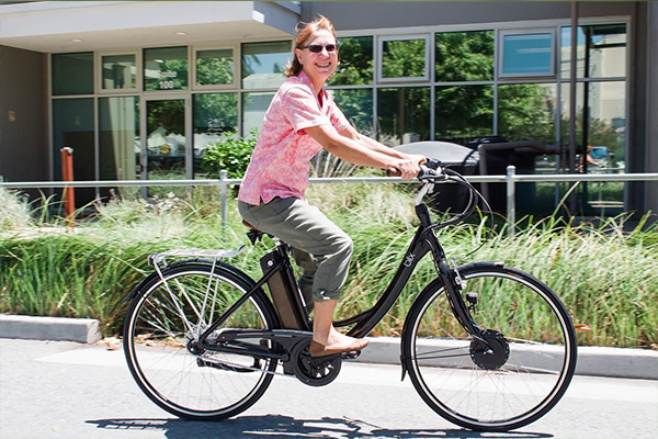 Happy girl riding SpinTech&trade; ebike